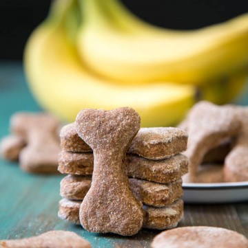 Peanut butter banana dog treats propped up on a green table top