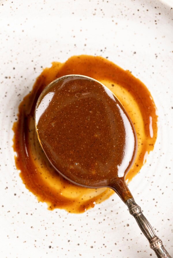 A spoon of homemade dulce de leche on a plate.
