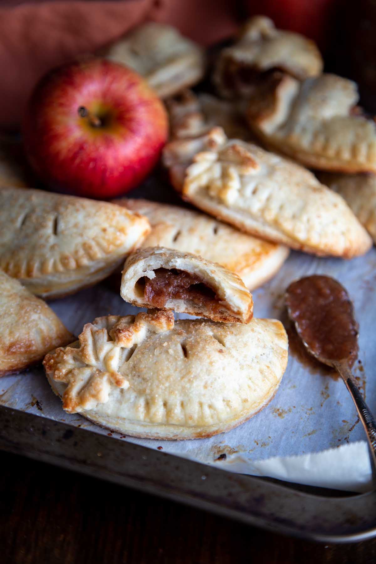 An apple hand pie broken in half to reveal apple butter as filling