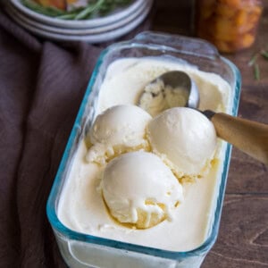 Scoops of mascarpone ice cream in a glass container