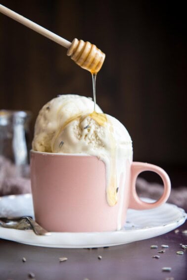 Honey drizzling into a cup of lavender ice cream.