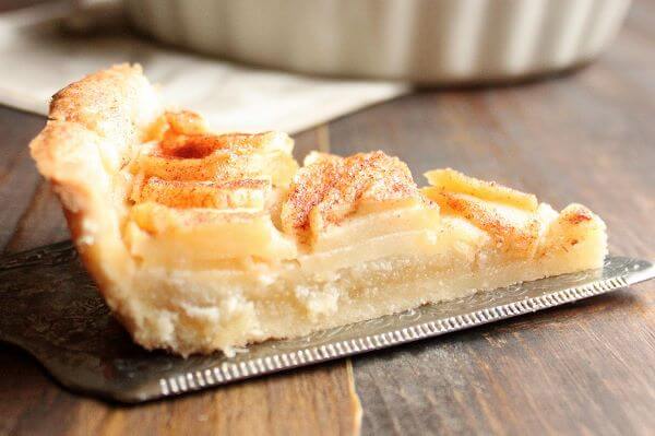 This Apple Tart has a hidden layer of delicious homemade almond paste underneath the apples. It is a wonderful dessert for Fall and will for sure be a hit at any of your holiday dinner parties. | wildwildwhisk.com