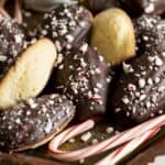 A tray of chocolate dipped madeleines garnished with crushed peppermint candies.