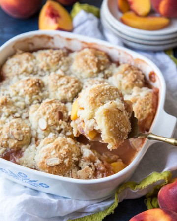 Serving peach cobbler from the baking pan