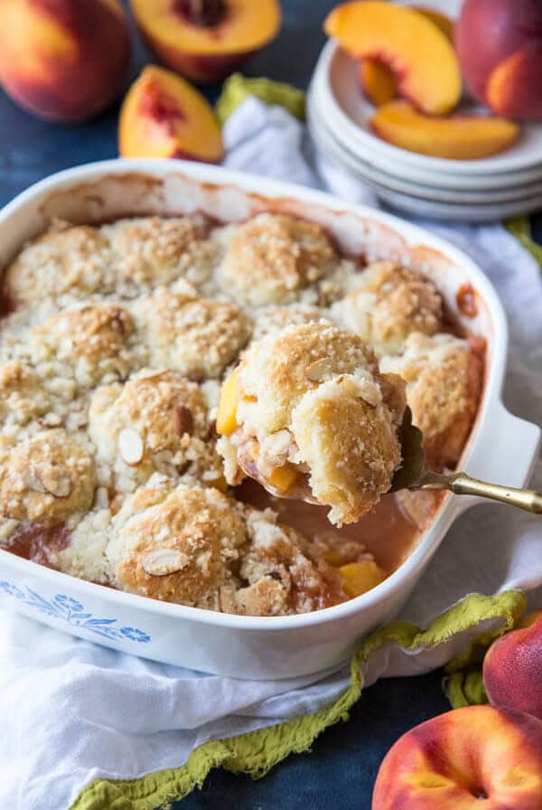 Serving peach cobbler from the baking pan