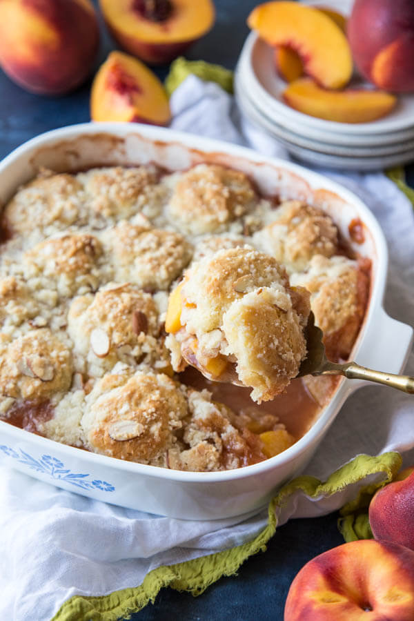 Serving peach cobbler from the baking pan