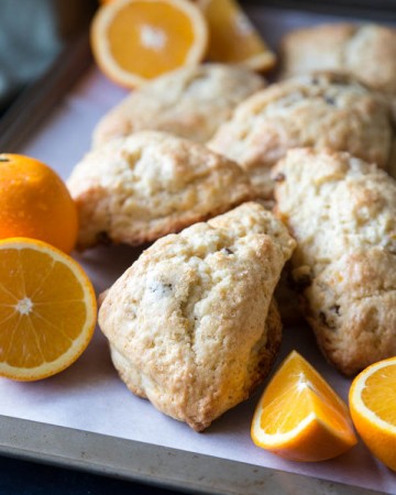 Orange scones on a baking trays with orange slices