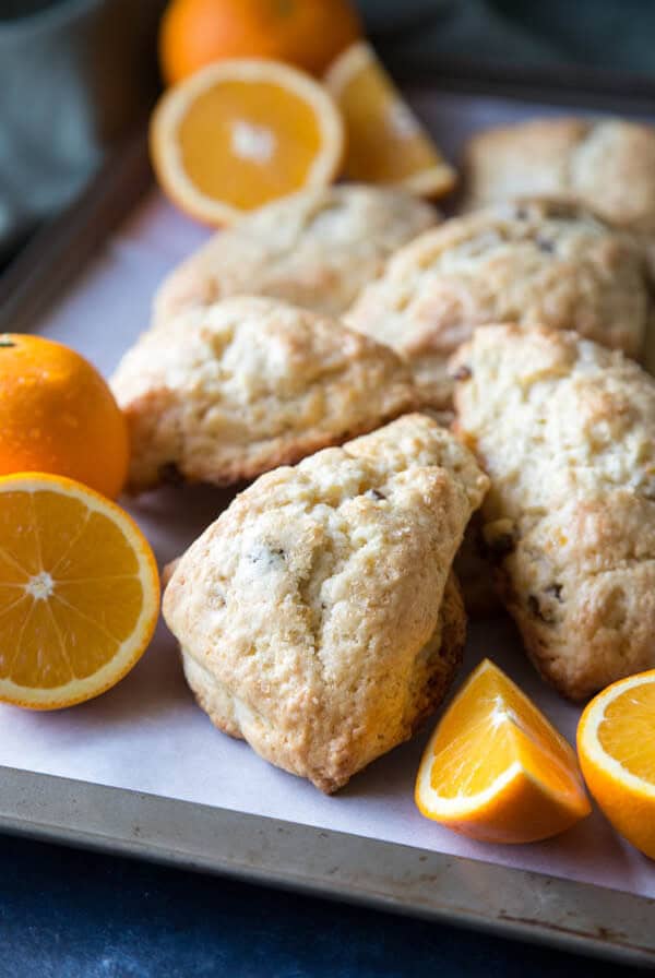 Orange scones on a baking trays with orange slices