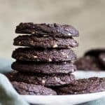 A stack of 5 chocolate mint chip cookies.