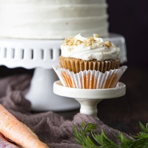 A carrot cupcake on a mini cake stand.