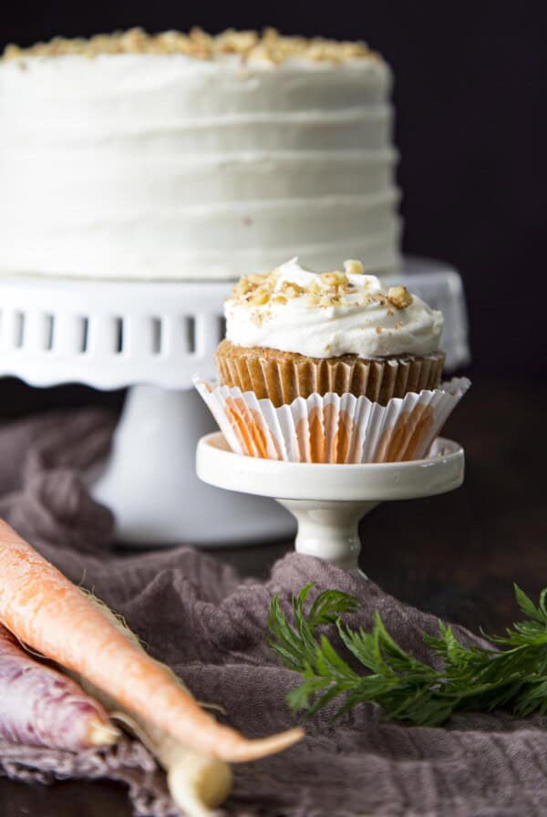 A carrot cupcake on a mini cake stand.