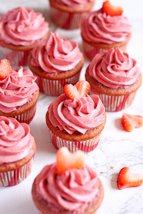These Strawberry Champagne Cupcakes are soft and moist with a creamy and tangy Moscato infused strawberry cream cheese frosting. | wildwildwhisk.com