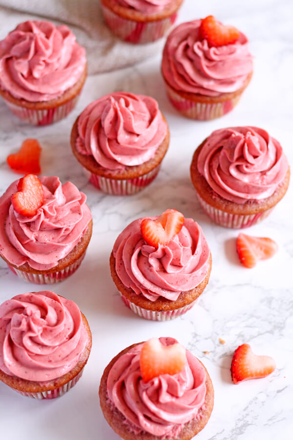 These Strawberry Champagne Cupcakes are soft and moist with a creamy and tangy Moscato infused strawberry cream cheese frosting. | wildwildwhisk.com