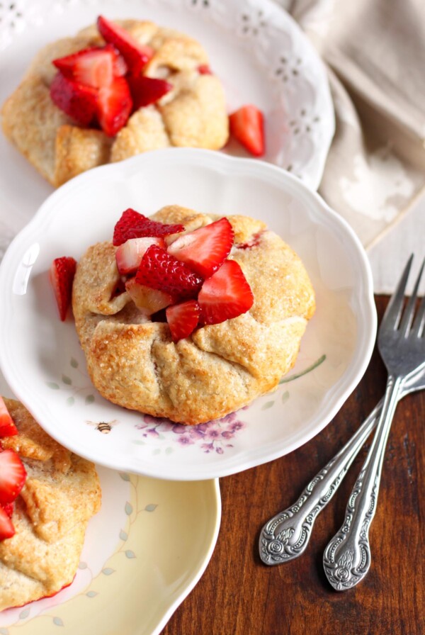Strawberry galettes on plates stacked on top of each other.