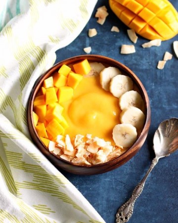 Mango peach smoothie in a wooden bowl