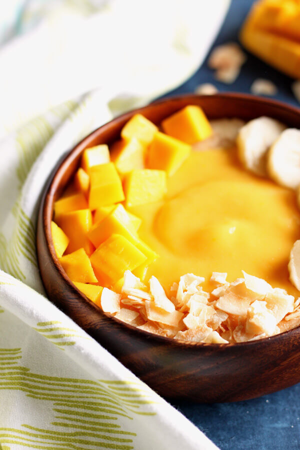 Mango peach smoothie in a wooden bowl