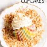 A pina colada cupcake laying on its side on top of toasted coconut on a plate.