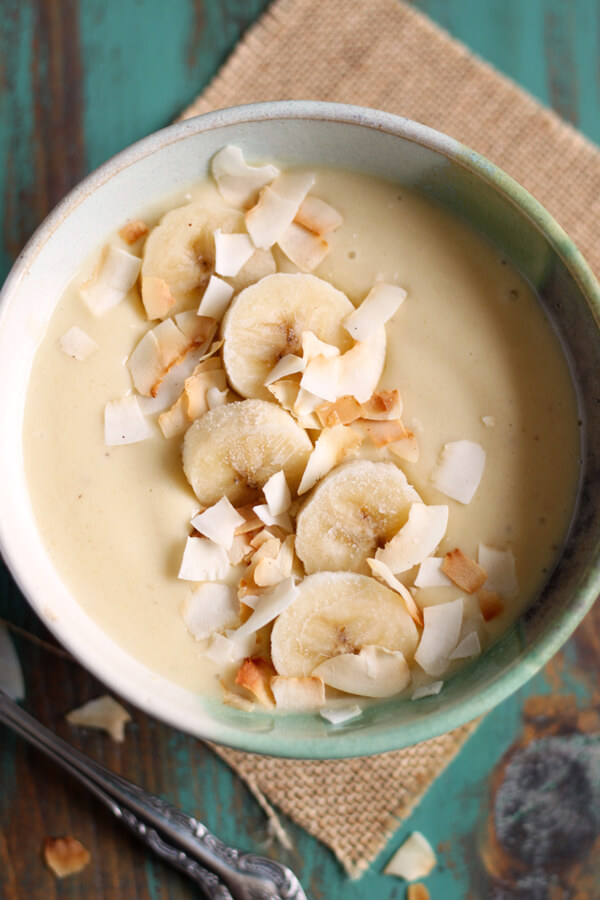 This easy Pina Colada Smoothie Bowl (minus the rum) is a healthy and tropical breakfast that will take you to the island in a spoon! | wildwildwhisk.com