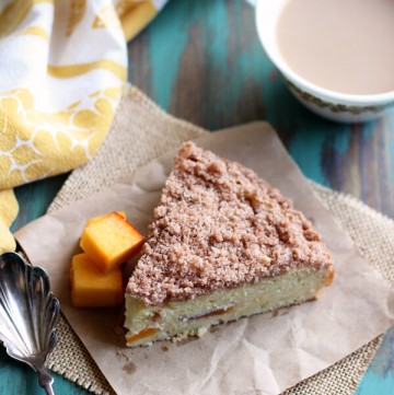 A slice of peach coffee cake on brown paper square