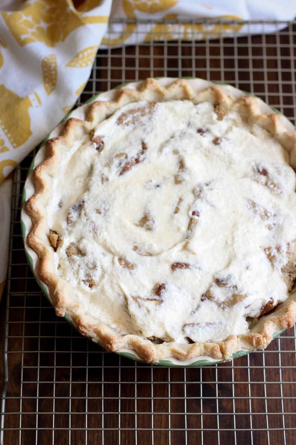 This Cookie Bomb Pie is modeled after the Baltimore Bomb Pie. It has a decadent filling using chocolate chip cookies and a buttery custard. | wildwildwhisk.com