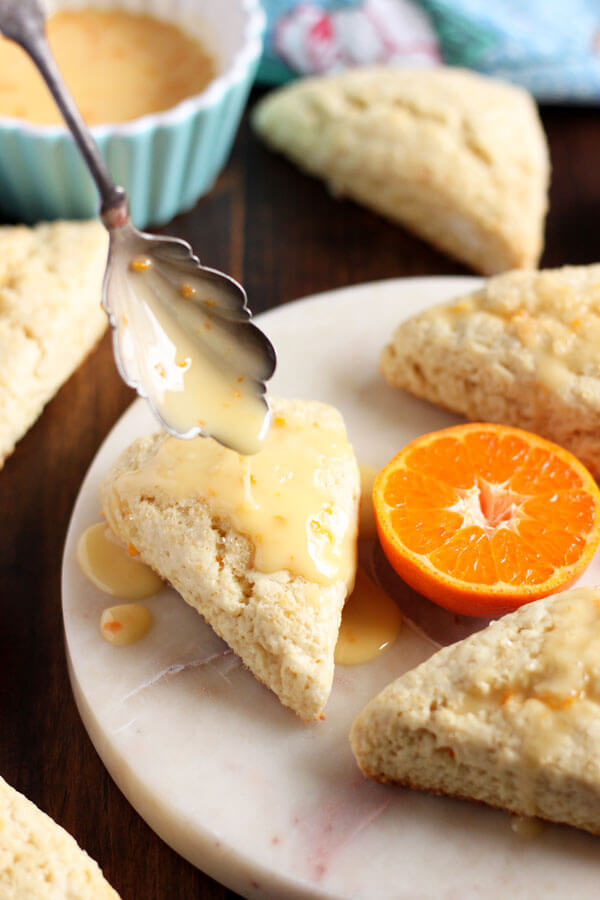 These Clementine Cream Scones are infused with refreshing clementine flavor in the scone batter, and in the tangy sweet glaze with lots of clementine zest. | wildwildwhisk.com