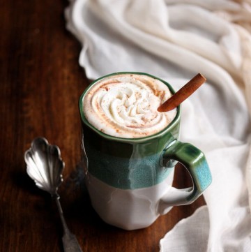 Pumpkin spice hot chocolate in a mug with whipped cream