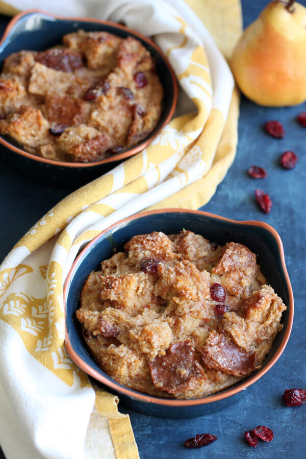 This Pear Cranberry Bread Pudding is a simple yet decadent dessert, baked up nicely in individual ramekins for easy sharing. | wildwildwhisk.com