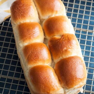 A loaf of Japanese milk bread on a wire rack.