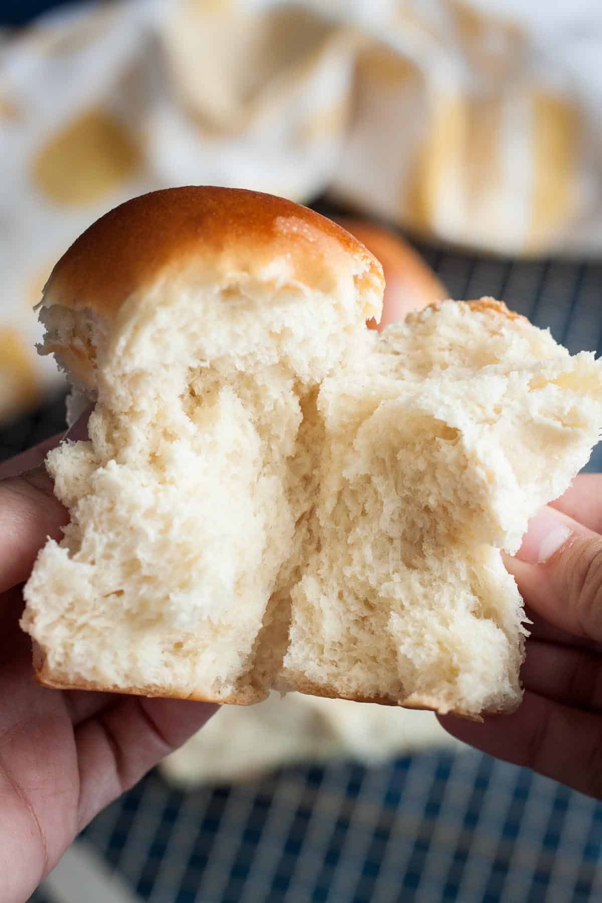 A piece of milk bread being pulled apart.