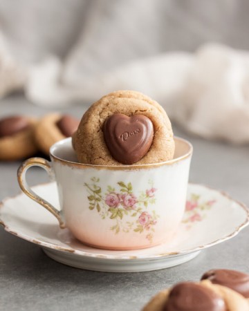 A peanut butter blossom cookie in a tea cup