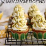 Rows of pistachio cupcakes on a wire rack.