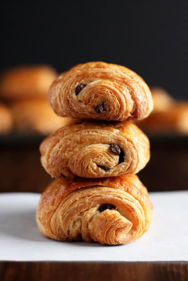 A stack of 3 chocolate croissants.