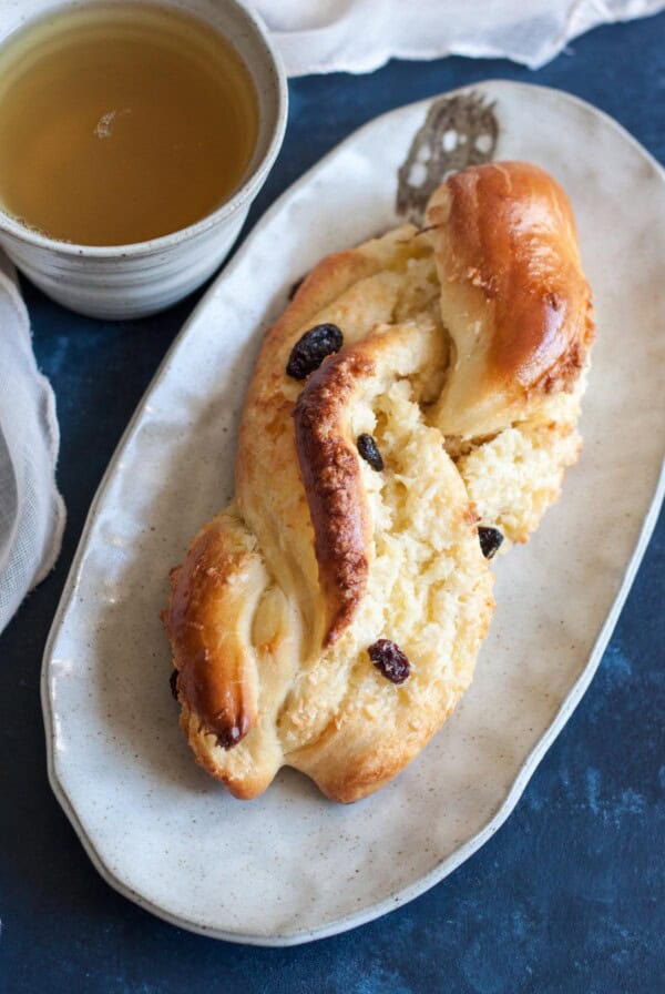 Asian Coconut Buns on a plate next to a tea cup,