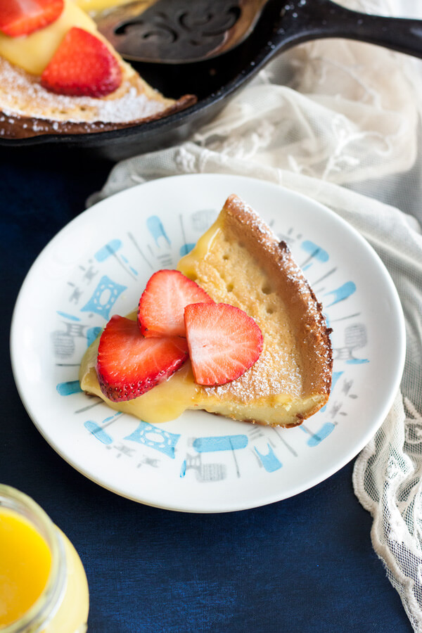 A Lemon Dutch Baby slice on a plate