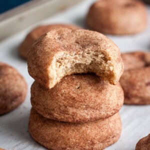 A stack of 3 Snickerdoodle Cookies without cream of tartar, the top one has a bite taken out.