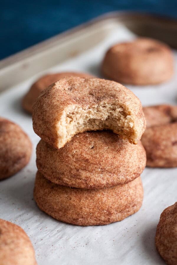 A stack of 3 Snickerdoodle Cookies without cream of tartar, the top one has a bite taken out.