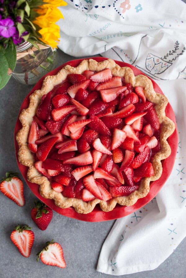 Strawberry cream cheese pie next to a white tea towel.