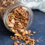 A jar of coconut granola on its side with granola spilling out of it.