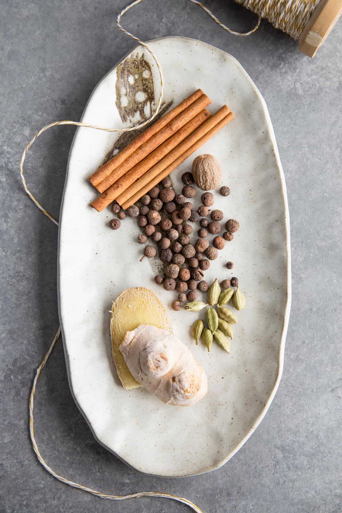 Whole spices in apple pie spice on a plate.