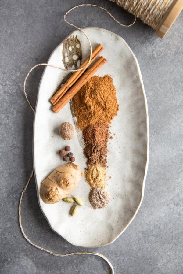 Ground spices for apple pie spice on a plate.