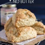 One cream scone's stacked on top of three other.