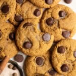 A pile of miso pumpkin cookies, the one on top has a bit taken out of it.