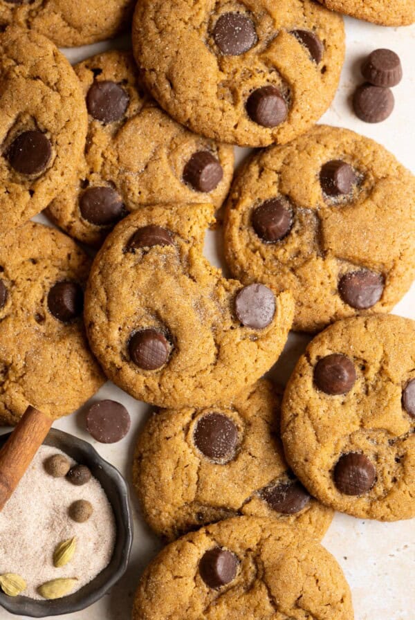 A pile of miso pumpkin cookies, the one on top has a bit taken out of it.