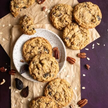 A stack of chewy oatmeal fig cookies on a cooking rack