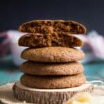 A stack of Ginger Molasses Cookies, the top two are broken in half.