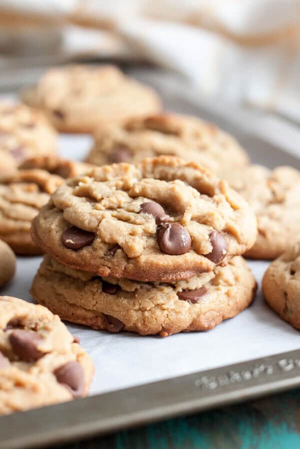 A stack of two peanut butter chocolate chip cookies on a baking sheet