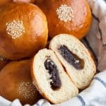 Anpan or Japanese Red Bean Buns in a basket with one cut open