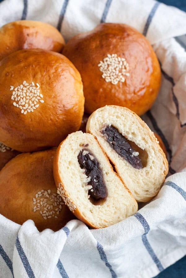 Anpan or Japanese Red Bean Buns in a basket with one cut open