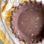 Chocolate pie crust next to a yellow towel.