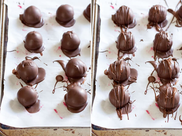 Raspberry truffles resting on a parchment line baking sheet